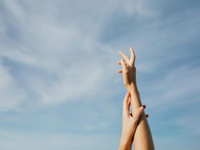 Person hands reaching for the sky during workout